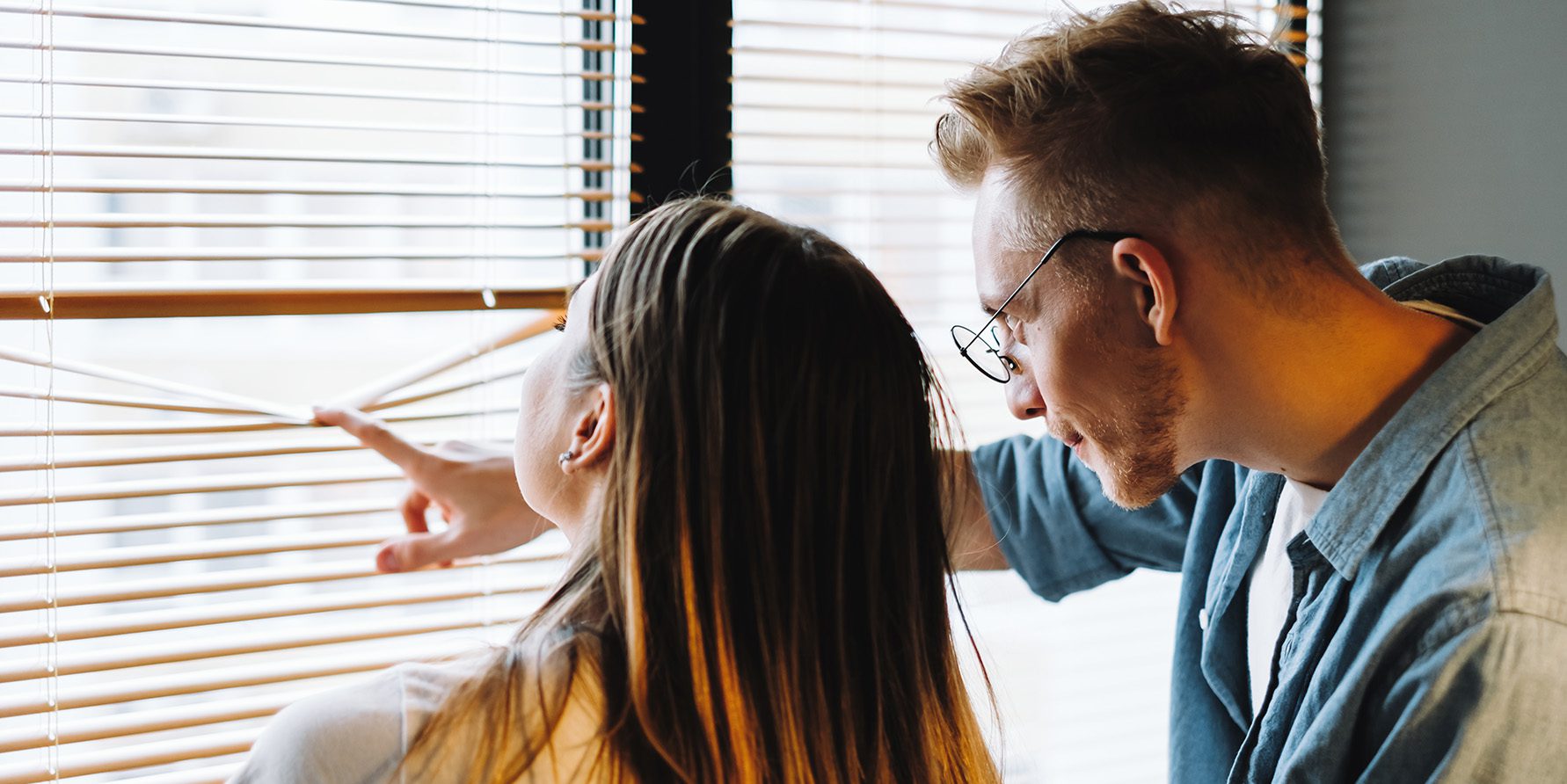 Couple looking out their window